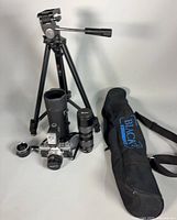 Group shot showing Olympus OM-1 camera with lens, Vivitar zoom lens in case, additional lens, Blacks BX45 tripod and carry bag