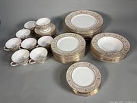 Overview of stacked dinner, salad, dessert plates, cereal bowls, teacups and saucers