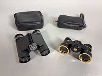 Both binoculars and their leather cases on display