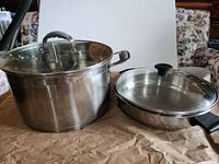 Tall stock pot and shallow sauté pan with lids in place