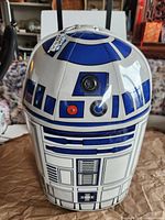Front view of R2-D2 carry case showing graphics, lens, control buttons, pull handle