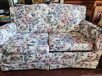 Front view of floral upholstered two-seat sofa