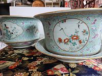 pair of planters on saucers showing overall design