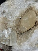 Close-up of cavity showing druzy crystals and two larger clear crystals