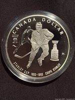 Reverse of coin featuring goalie and Stanley Cup