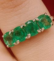 Top view showing emerald stones and prong settings