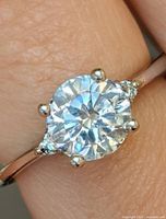 Ring on finger showing diamond and prongs