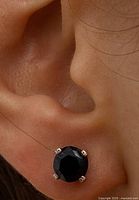 Earring worn on earlobe showing size and four-prong 14K setting