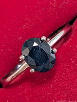 Close-up of silver ring with oval sapphire gemstone