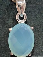 Front view of silver pendant with oval blue chalcedony