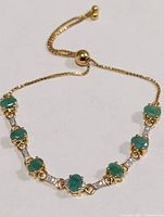 Full view of emerald bolo bracelet laid flat