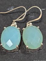 Front view of both earrings showing chalcedony stones and silver prong settings