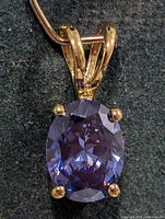 Front view of pendant showing gemstone color and prong setting