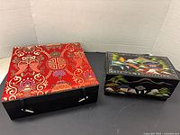 Both jewelry boxes closed, showing exterior designs