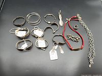 All 14 silver-plated jewellery pieces displayed on black background