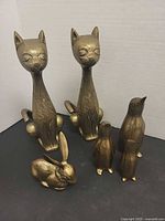 Group showing two cats, rabbit and three penguins