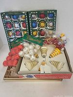 All items grouped: two Danson boxes, two Noma packs, spiral ornaments box, bead garland