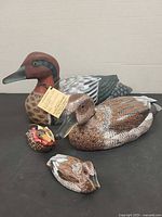 Two full-size duck decoys and two miniature ducks displayed together
