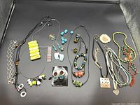 Full layout of assorted fused glass and beaded jewelry