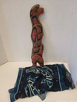 Front view of wood carving with scarf displayed