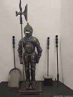 Full view of knight stand with four fireplace tools