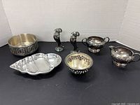 All six metal pieces arranged for size and style overview