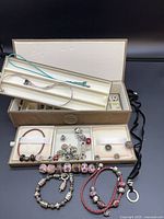 overview of open three-tier case showing beads, bracelets and necklace