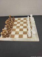 Full view of stone chess board with all pieces set up