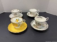 All four teacup and saucer sets displayed