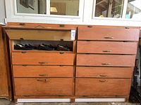 Full front view of wooden cabinet showing all drawers