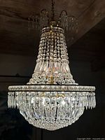 Full view of chandelier hanging from ceiling showing complete shape and crystal arrangement