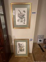 Both framed prints hung side by side to show matching size and style