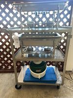 Full view of cart with pans, cooler, tray