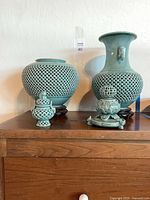 Group shot showing all four celadon pieces on dresser