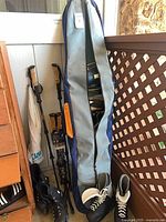 Full view of snowboard bag, inline skates, ice skates, trekking poles, fishing rod