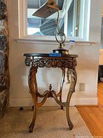 Side table with bankers lamp atop, full view