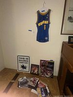Full lot showing jersey on wall, Sharks sign, Jordan print, magazines and brackets on floor