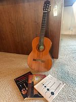Full view of Yamaha C-40 guitar and three books