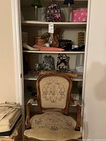 Closet shelves showing chair, lamps, bags, shoes, décor items