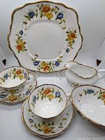 full seven-piece set with plate, cups, saucers, creamer, sugar bowl