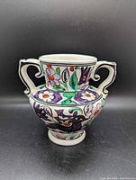 Front view showing hand-painted motifs and two handles