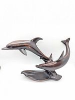 Front view showing two dolphins and base