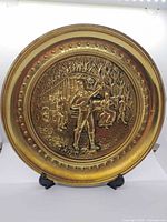 Front view of embossed brass plate showing full gypsy minstrel design and rim detail