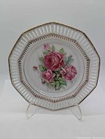 Front view of hexagonal plate showing rose motif and reticulated border