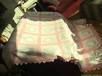 Full view of quilt draped over sofa showing overall color and pattern