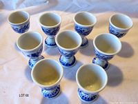 Nine blue and white egg cups arranged upright