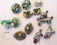 All seven pairs of earrings arranged on cloth background
