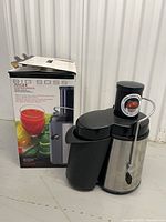 Juicer beside its retail box