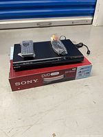 Player on top of retail box with remote and A/V cable