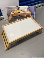 Wooden folding tray set up next to original box